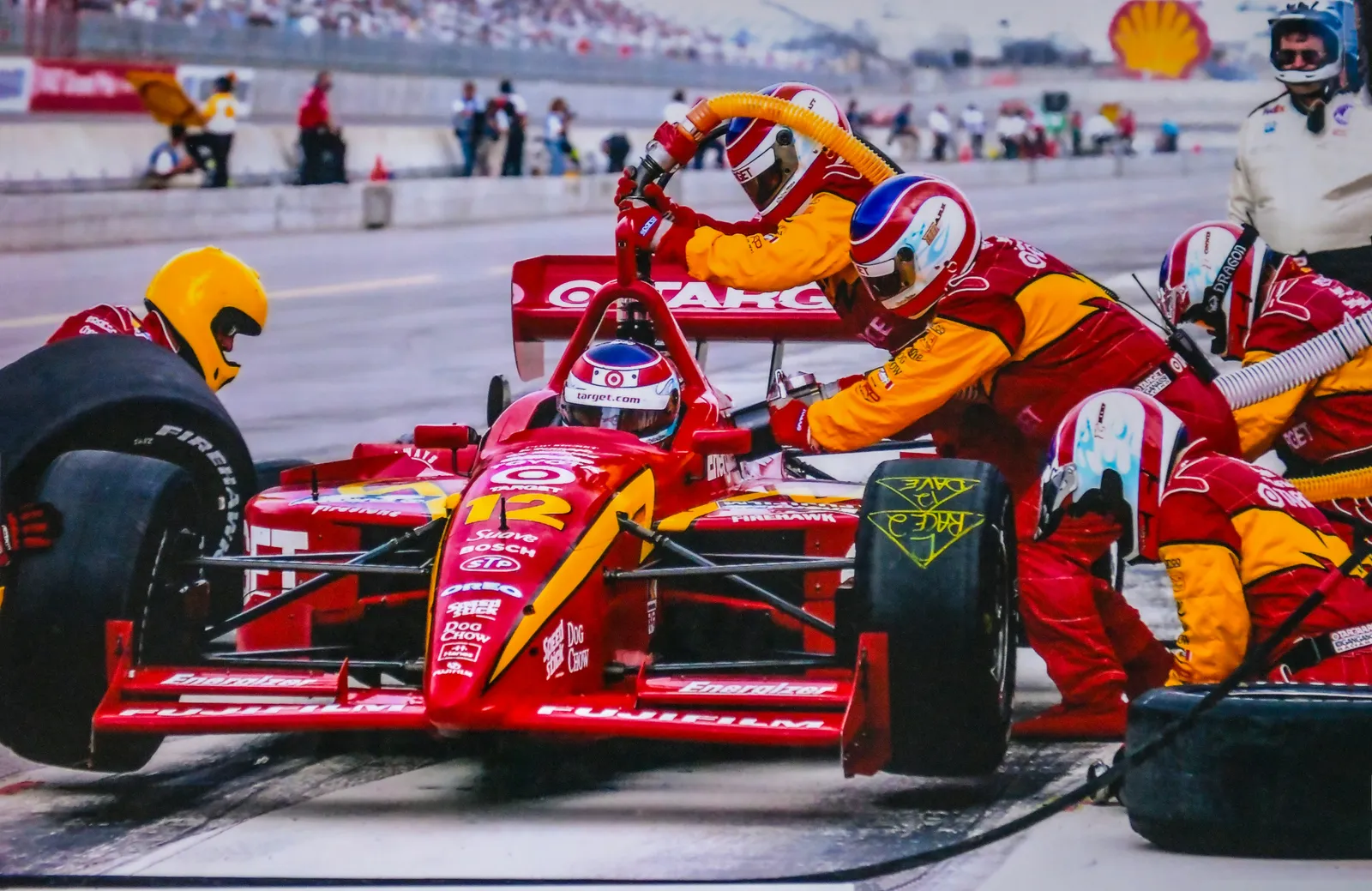 a group of men working on a race car